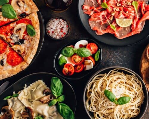 Full,Table,Of,Italian,Meals,On,Plates,Pizza,,Pasta,,Ravioli,